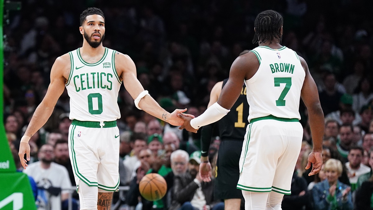 Boston Celtics forward Jayson Tatum (0) and guard Jaylen Brown (7) react after a play against the Cleveland Cavaliers in the first quarter during game two of the second round for the 2024 NBA playoffs at TD Garden.