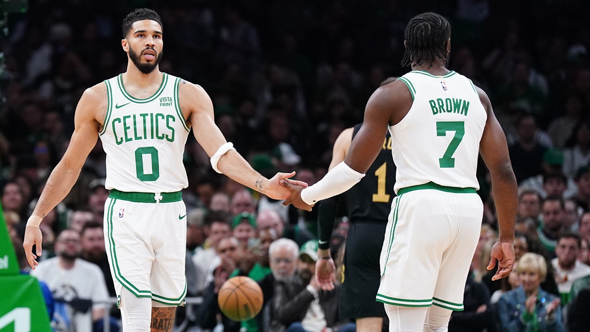 Boston Celtics forward Jayson Tatum (0) and guard Jaylen Brown (7) react after a play against the Cleveland Cavaliers in the first quarter during game two of the second round for the 2024 NBA playoffs at TD Garden. 