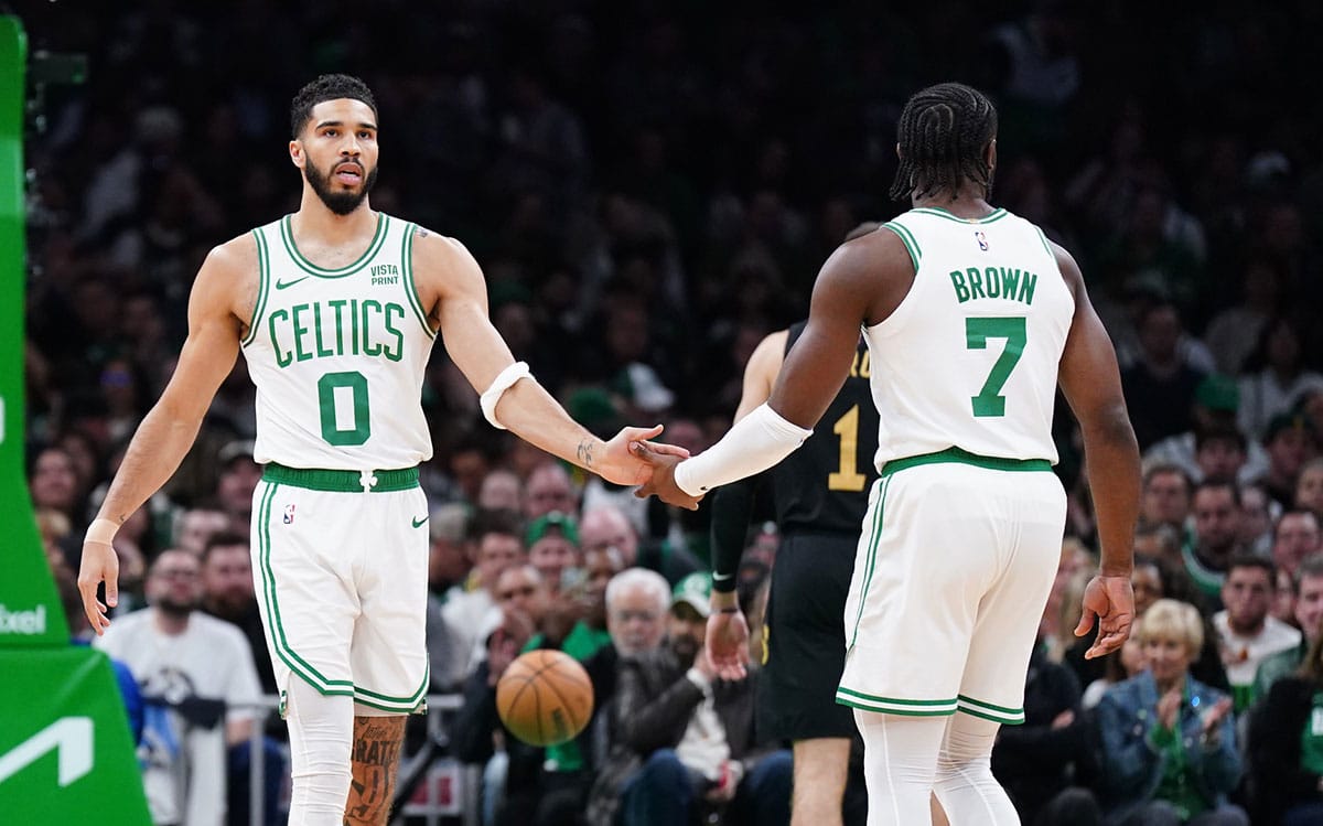 Boston Celtics forward Jayson Tatum (0) and guard Jaylen Brown (7) react after a play against the Cleveland Cavaliers in the first quarter during game two of the second round for the 2024 NBA playoffs at TD Garden. 