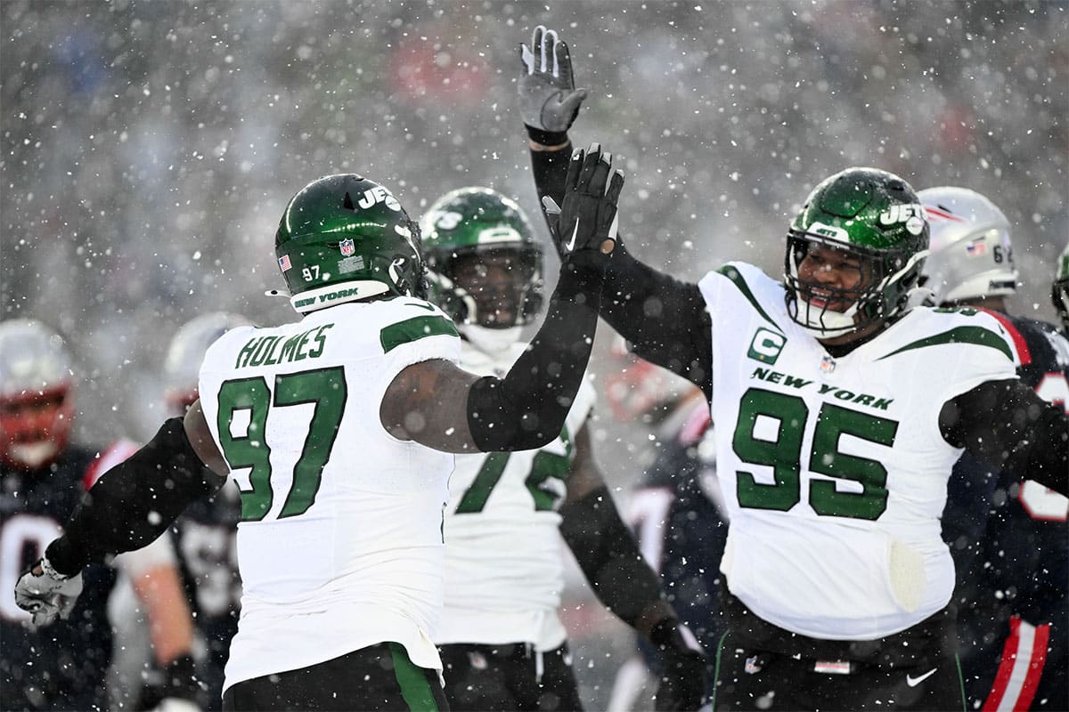 New York Jets defensive end Jalyn Holmes (97) celebrates with defensive tackle Quinnen Williams (95) after a sack against the New England Patriots during the second half at Gillette Stadium.