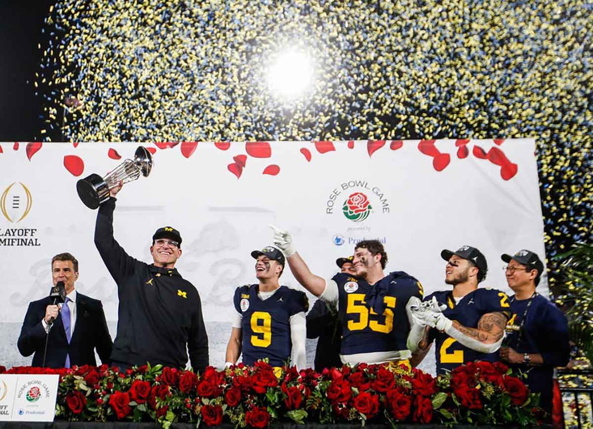 Michigan head coach Jim Harbaugh lifts up the Rose Bowl trophy after a 27-20 win over Alabama in the College Football Playoff semifinal at the Rose Bowl