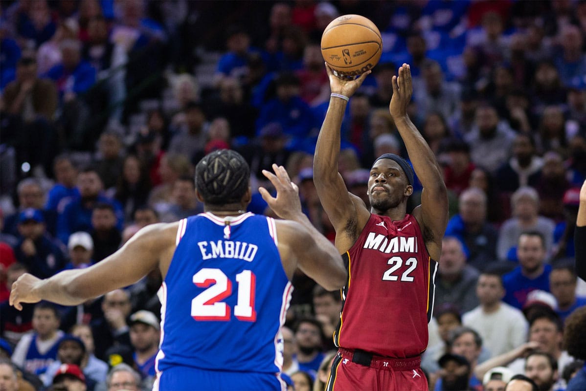 Miami Heat forward Jimmy Butler (22) shoots past Philadelphia 76ers center Joel Embiid (21) during the second quarter of a play-in game of the 2024 NBA playoffs at Wells Fargo Center.