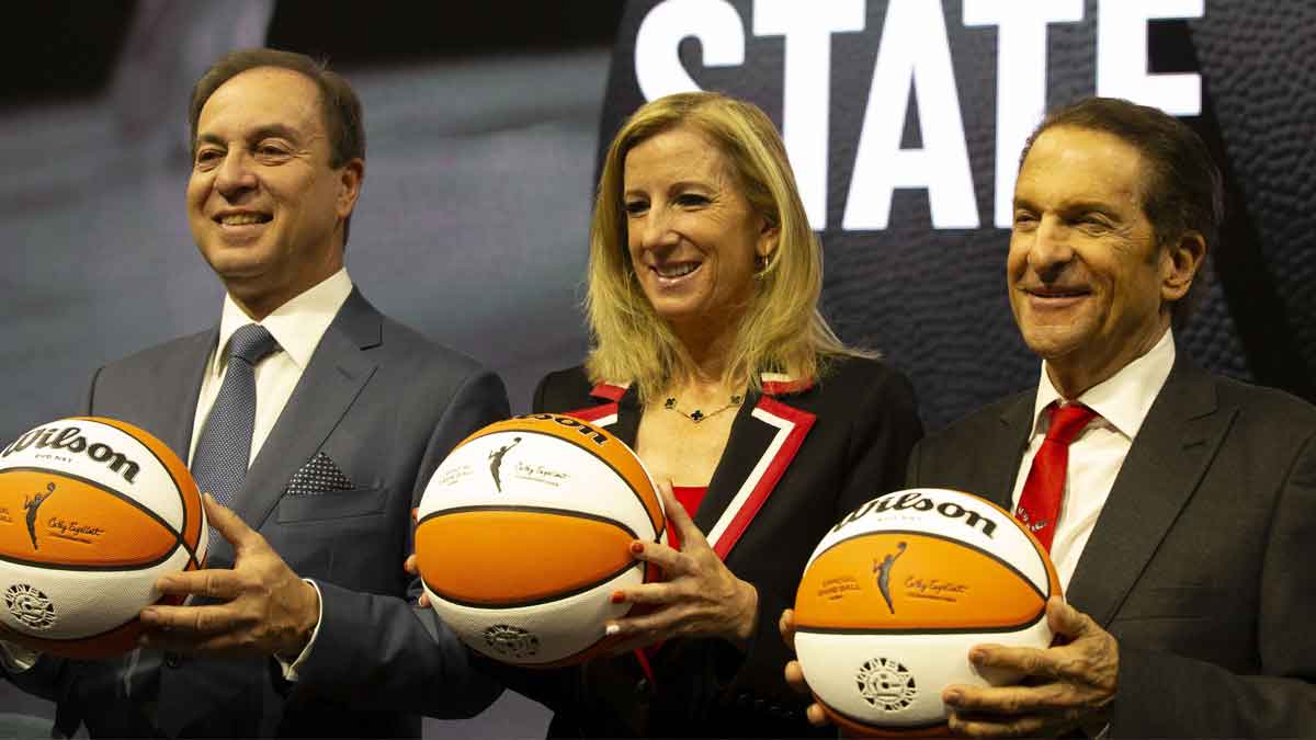 Golden State Warriors co-executive director & chief executive officer Joe Lacob, WNBA commissioner Cathy Engelbert and Warriors co-executive director Peter Guber pose for a group photo during a press conference to announce an expansion WNBA franchise in the San Francisco Bay Area at Chase Center.