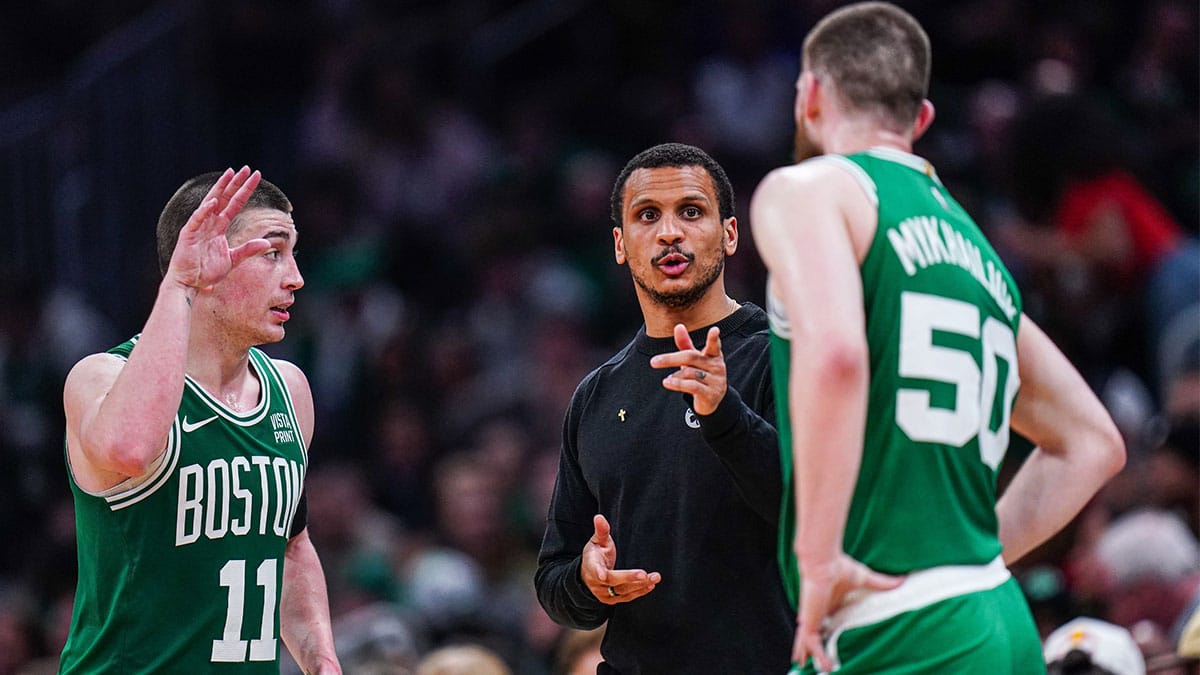 Boston Celtics head coach Joe Mazzulla talks with guard Svi Mykhailiuk (50) and guard Payton Pritchard (11) from the sideline as they take on the Charlotte Hornets at TD Garden.