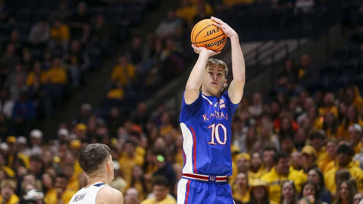 Kansas Jayhawks guard Johnny Furphy (10) shoots a three-point shot over West Virginia Mountaineers guard Kerr Kriisa (3) during the first half at WVU Coliseum.