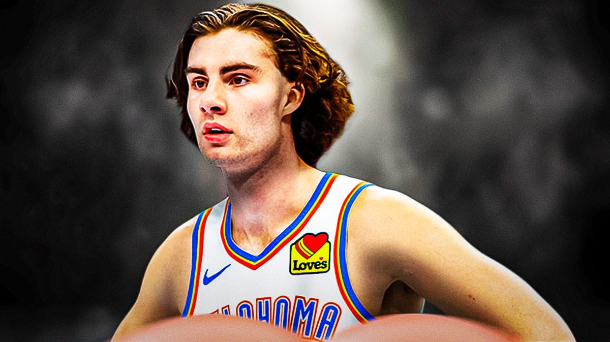 Thunder's Josh Giddey close-up image looking serious in a dark room.