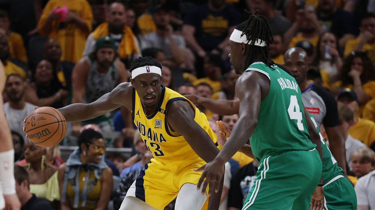 Indiana Pacers forward Pascal Siakam (43) controls the ball against Boston Celtics guard Jrue Holiday (4) during the fourth quarter of game three of the eastern conference finals in the 2024 NBA playoffs at Gainbridge Fieldhouse.