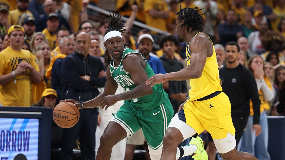 Boston Celtics guard Jrue Holiday (4) brings the ball up court against Indiana Pacers forward Aaron Nesmith (23) during the fourth quarter of game three of the eastern conference finals in the 2024 NBA playoffs at Gainbridge Fieldhouse. 