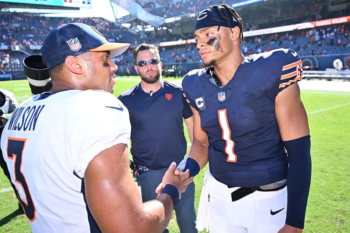 Chicago Bears quarterback Justin Fields (1), right, meets with Denver Broncos quarterback Russell Wilson (3) at midfield after their game at Soldier Field. 