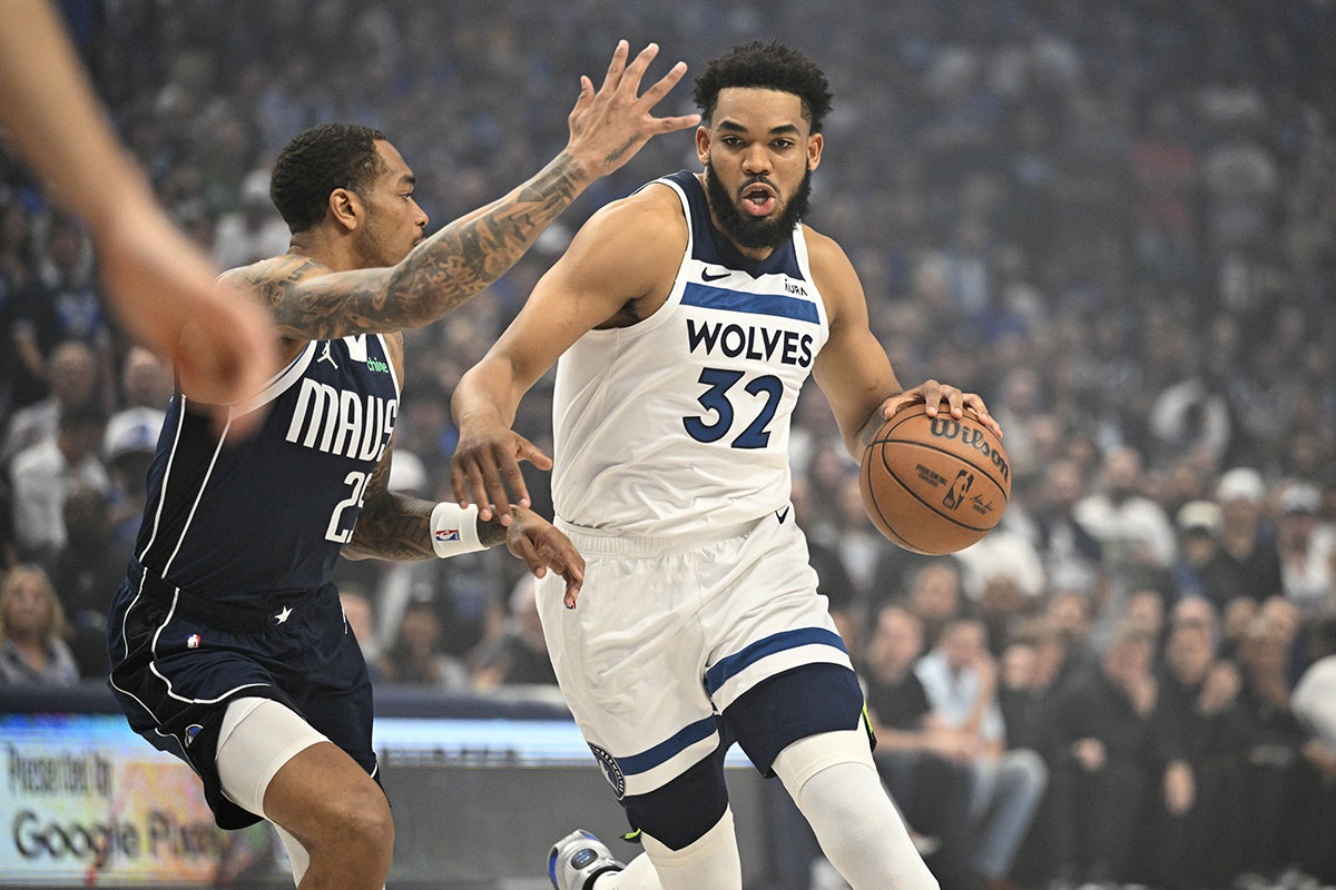 Minnesota Timberwolves center Karl-Anthony Towns (32) controls the ball against Dallas Mavericks forward P.J. Washington (25) in the first quarter during game three of the western conference finals for the 2024 NBA playoffs at American Airlines Center. 