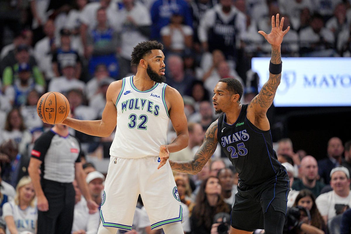 Minnesota Timberwolves center Karl-Anthony Towns (32) controls the ball against Dallas Mavericks forward P.J. Washington (25) in the third quarter during game two of the western conference finals for the 2024 NBA playoffs at Target Center.