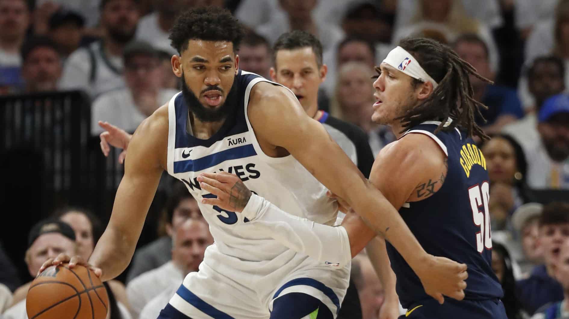 Timberwolves forward Karl-Anthony Towns (32) works around Denver Nuggets forward Aaron Gordon (50) in the first quarter of game four of the second round for the 2024 NBA playoffs at Target Center