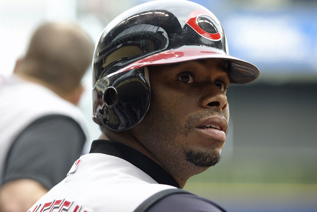 Ken Griffey Jr. #30 of the Cincinnati Reds waits at the edge of the dugout