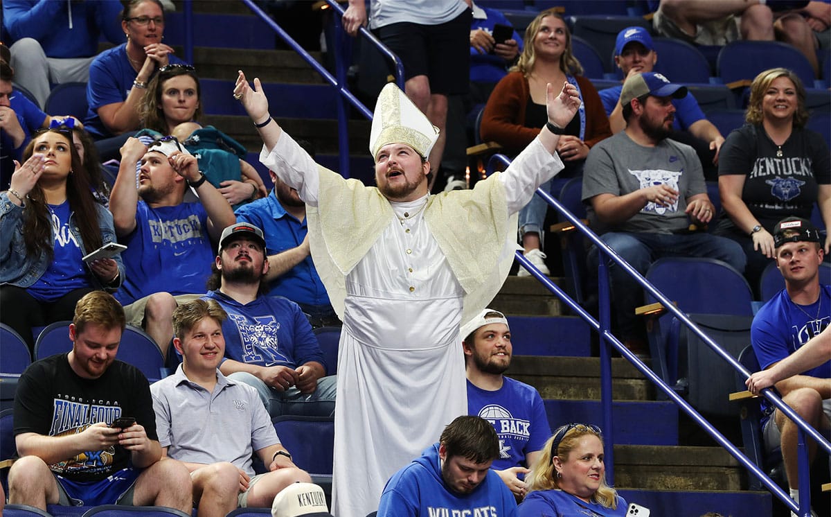 A Kentucky basketball fan in a pope costume at Mark Pope's introductory press conference.