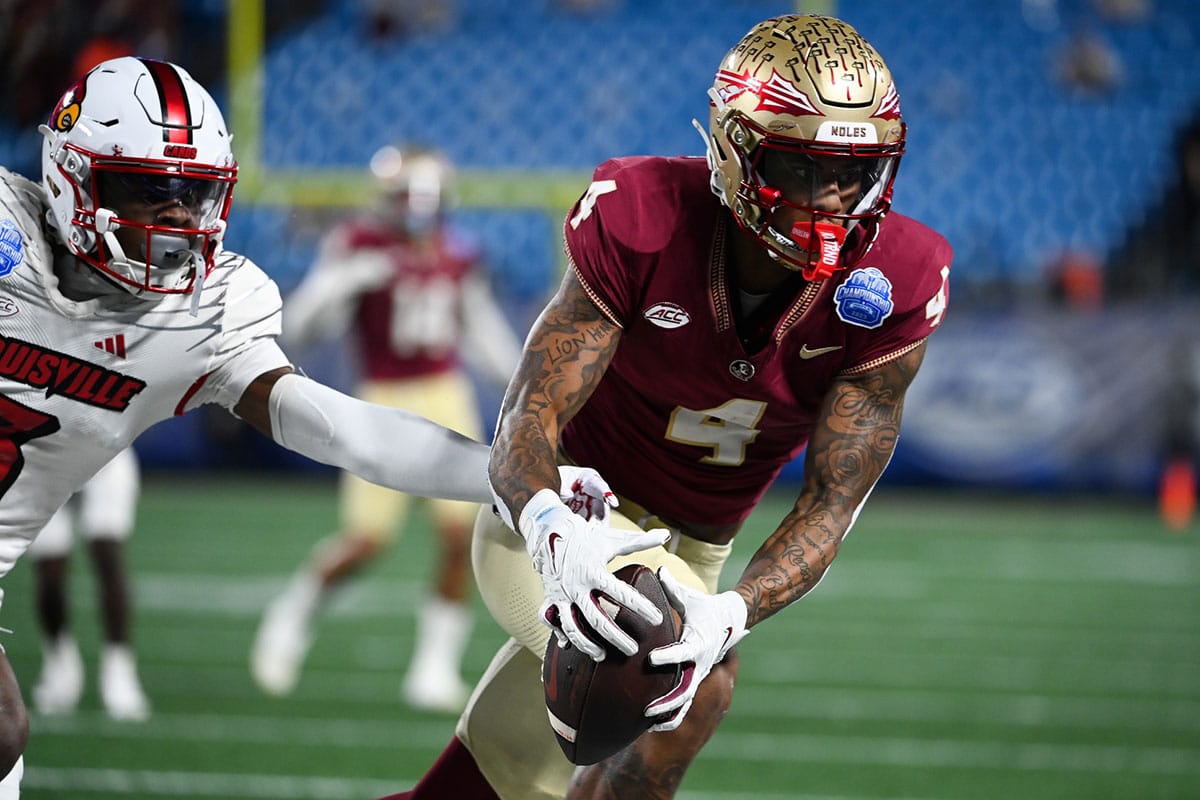 Florida State Seminoles wide receiver Keon Coleman (4) makes a catch against the Louisville Cardinals in the second quarter at Bank of America Stadium.
