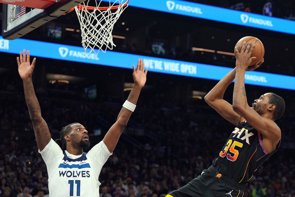 Phoenix Suns forward Kevin Durant (35) shoots over Minnesota Timberwolves center Naz Reid (11) during the second half of game four of the first round for the 2024 NBA playoffs at Footprint Center.