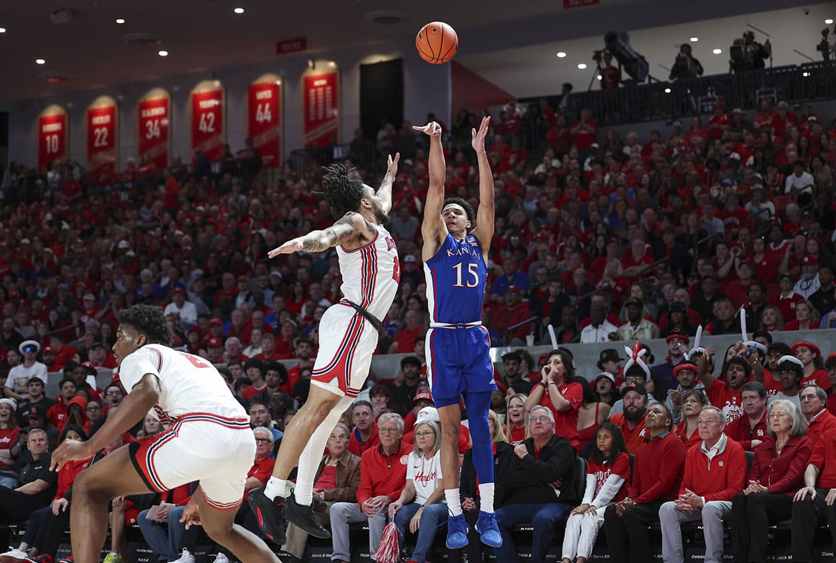 Kansas Jayhawks guard Kevin McCullar Jr. (15) shoots the ball as Houston Cougars guard Emanuel Sharp (21) defends during the first half at Fertitta Center.