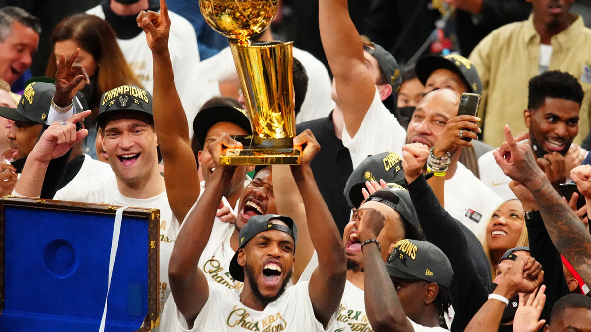 Milwaukee Bucks forward Khris Middleton (22) celebrates with the Larry O'Brien Trophy after game six of the 2021 NBA Finals and the championship against the Phoenix Suns at Fiserv Forum.
