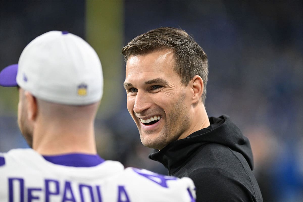 Minnesota Vikings quarterback Kirk Cousins (8) smiles with teammates prior to their game against the Detroit Lions at Ford Field.