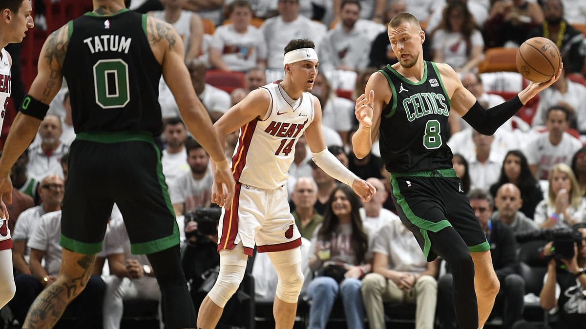  Boston Celtics center Kristaps Porzingis (8) turns on Miami Heat guard Tyler Herro (14) during the first quarter of game four of the first round for the 2024 NBA playoffs at Kaseya Center.