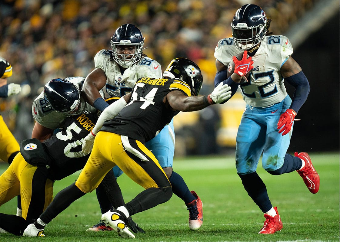 Tennessee Titans running back Derrick Henry (22) runs the ball against Pittsburgh Steelers linebacker Kwon Alexander (54) during the second quarter of their game at Acrisure Stadium in Pittsburgh, Penn.