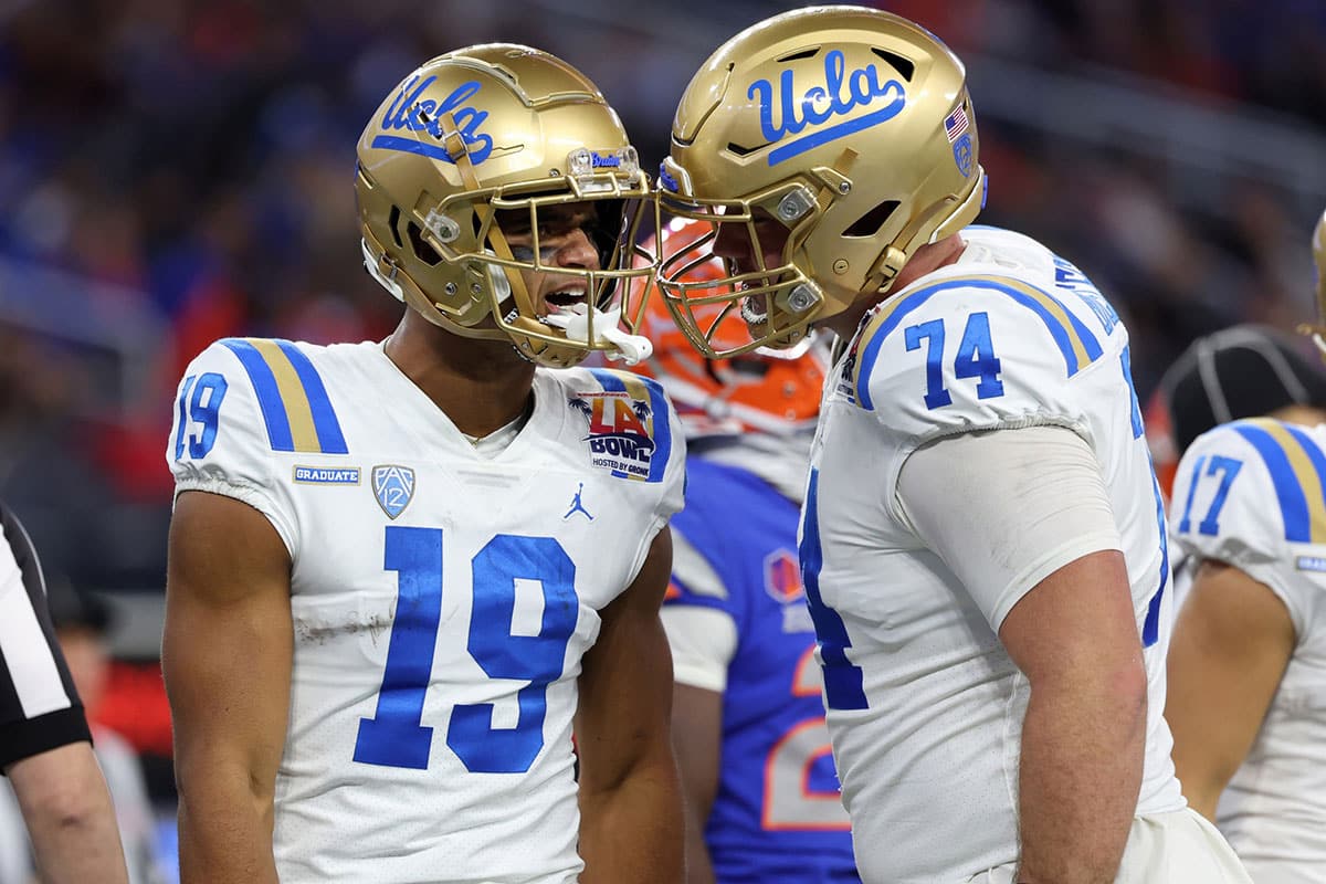 UCLA Bruins wide receiver Kyle Ford (19) celebrates with offensive lineman Spencer Holstege (74) after catching a touchdown pass during the third quarter of the LA Bowl at SoFi Stadium.