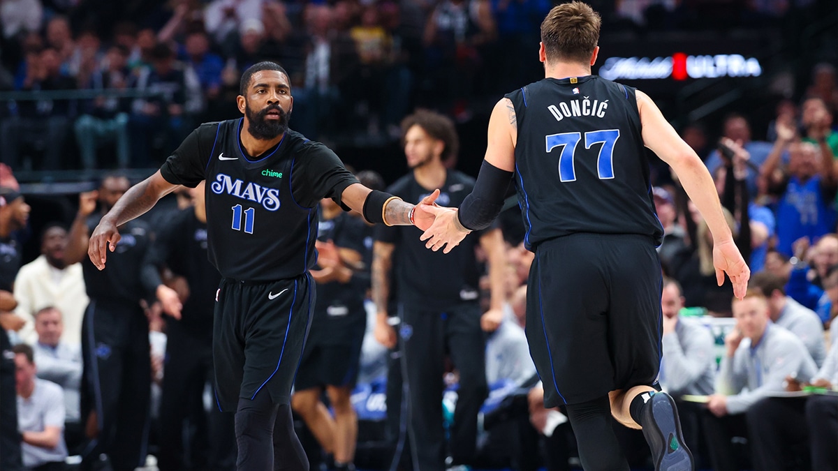 Dallas Mavericks guard Kyrie Irving (11) celebrates with Dallas Mavericks guard Luka Doncic (77) during the first half against the Utah Jazz at American Airlines Center.