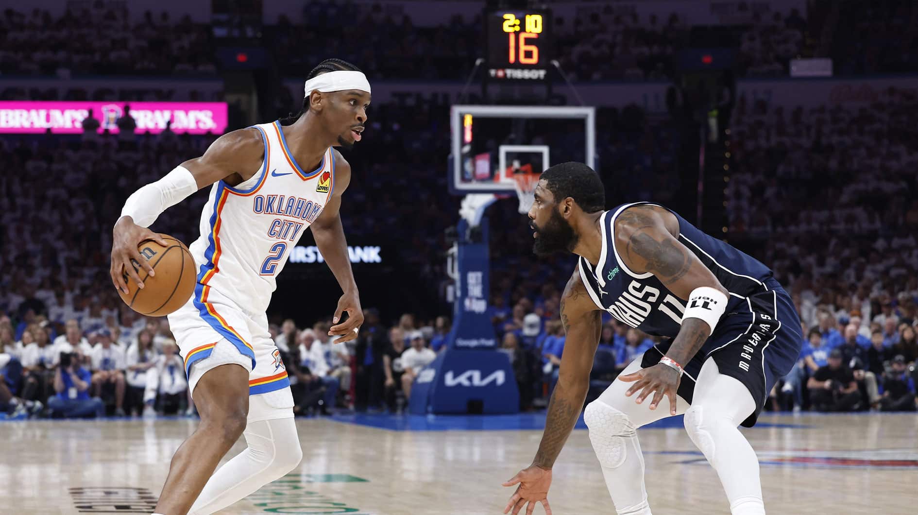 Oklahoma City Thunder guard Shai Gilgeous-Alexander (2) works his way to the basket against Dallas Mavericks guard Kyrie Irving (11) during the second quarter of game one of the second round for the 2024 NBA playoffs at Paycom Center.