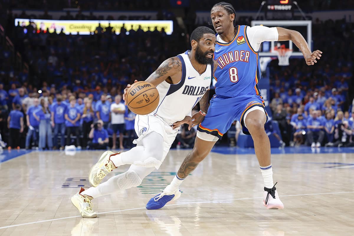 Dallas Mavericks guard Kyrie Irving (11) drives around Oklahoma City Thunder forward Jalen Williams (8) during the second half of game two of the second round for the 2024 NBA playoffs at Paycom Center.