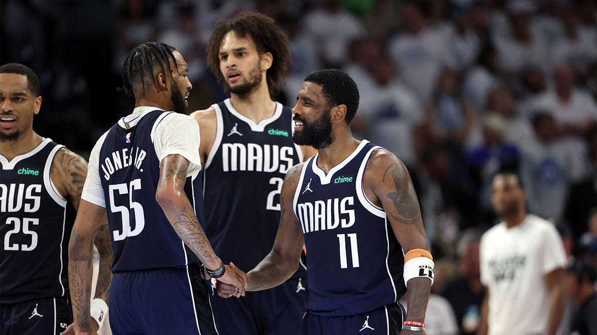 Dallas Mavericks guard Kyrie Irving (11) and forward Derrick Jones Jr. (55) celebrate after defeating the Minnesota Timberwolves in game one of the western conference finals for the 2024 NBA playoffs at Target Center.