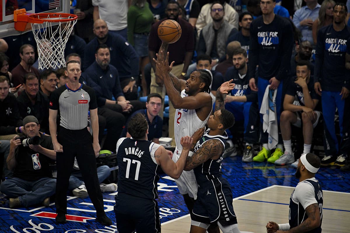 Apr 26, 2024; Dallas, Texas, USA; LA Clippers forward Kawhi Leonard (2) shoots the ball over Dallas Mavericks guard Luka Doncic (77) during the first quarter during game three of the first round for the 2024 NBA playoffs at the American Airlines Center. Mandatory Credit: Jerome Miron-USA TODAY Sports