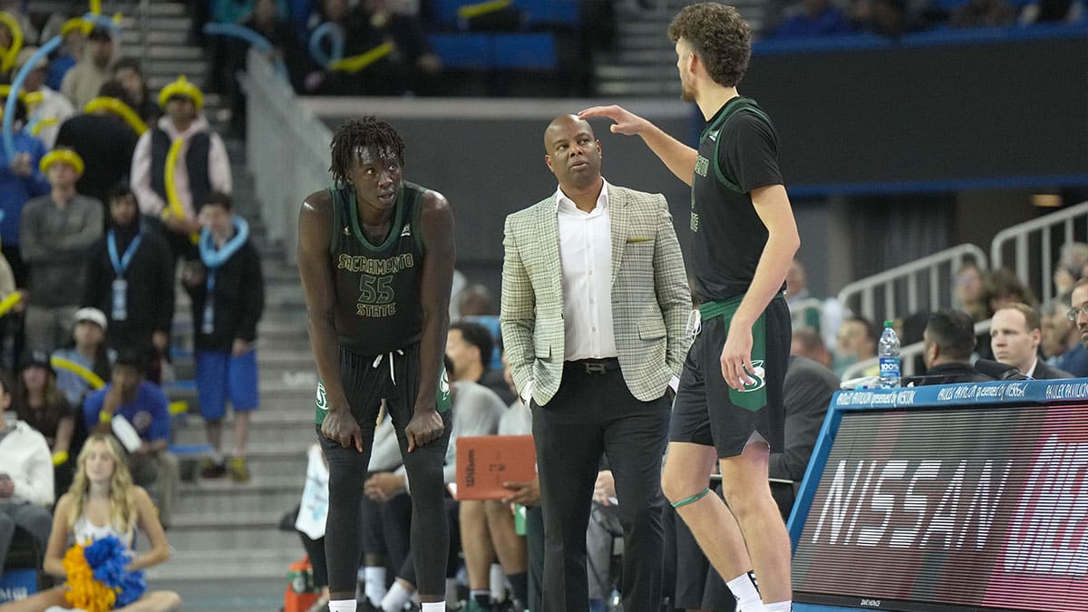 Sacramento State Hornets head coach David Patrick (center) talks with forward Akol Mawein (55) and forward Hunter Marks (0) in the second half against the UCLA Bruins at Pauley Pavilion.