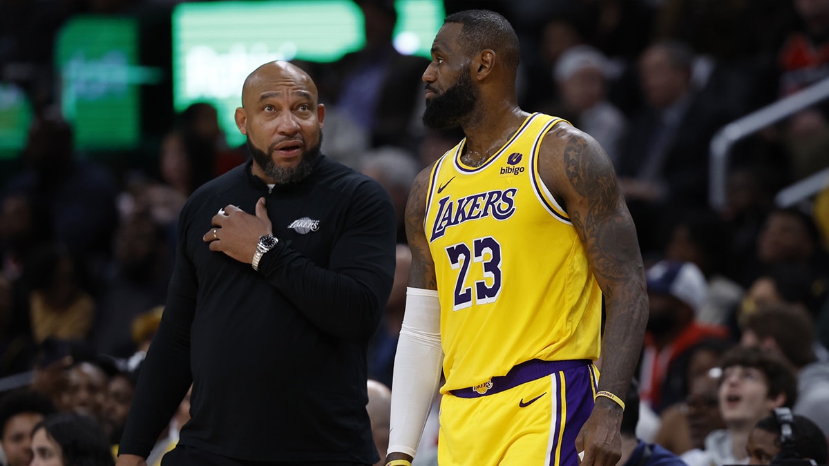 Lakers star LeBron James talks with Darvin Ham.