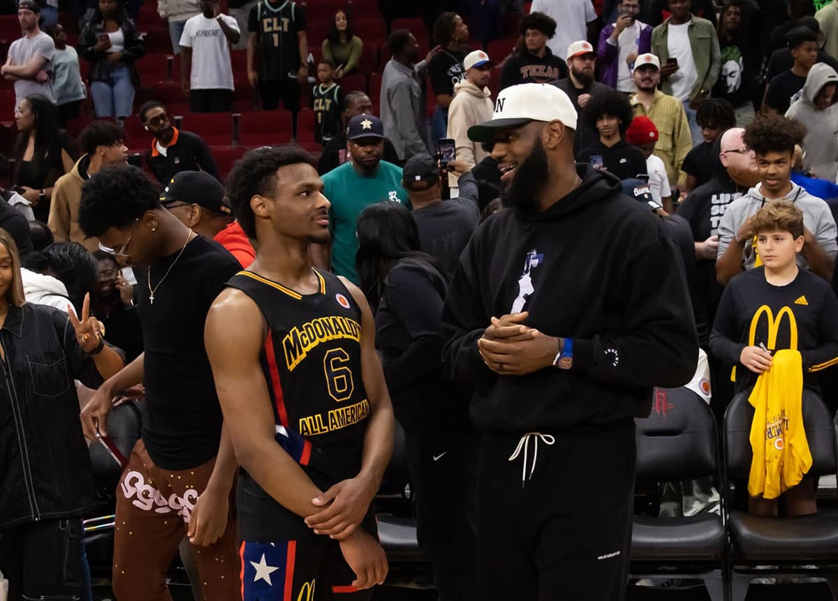 West guard Bronny James (6) with father LeBron James following the McDonald's All American Boy's high school basketball game at Toyota Center.