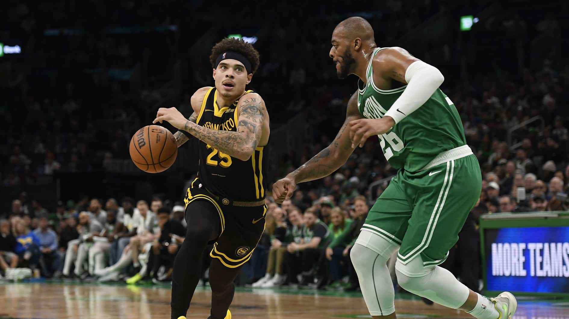 Golden State Warriors guard Lester Quinones (25) drives to the basket while Boston Celtics forward Xavier Tillman (26) defends during the second half at TD Garden.