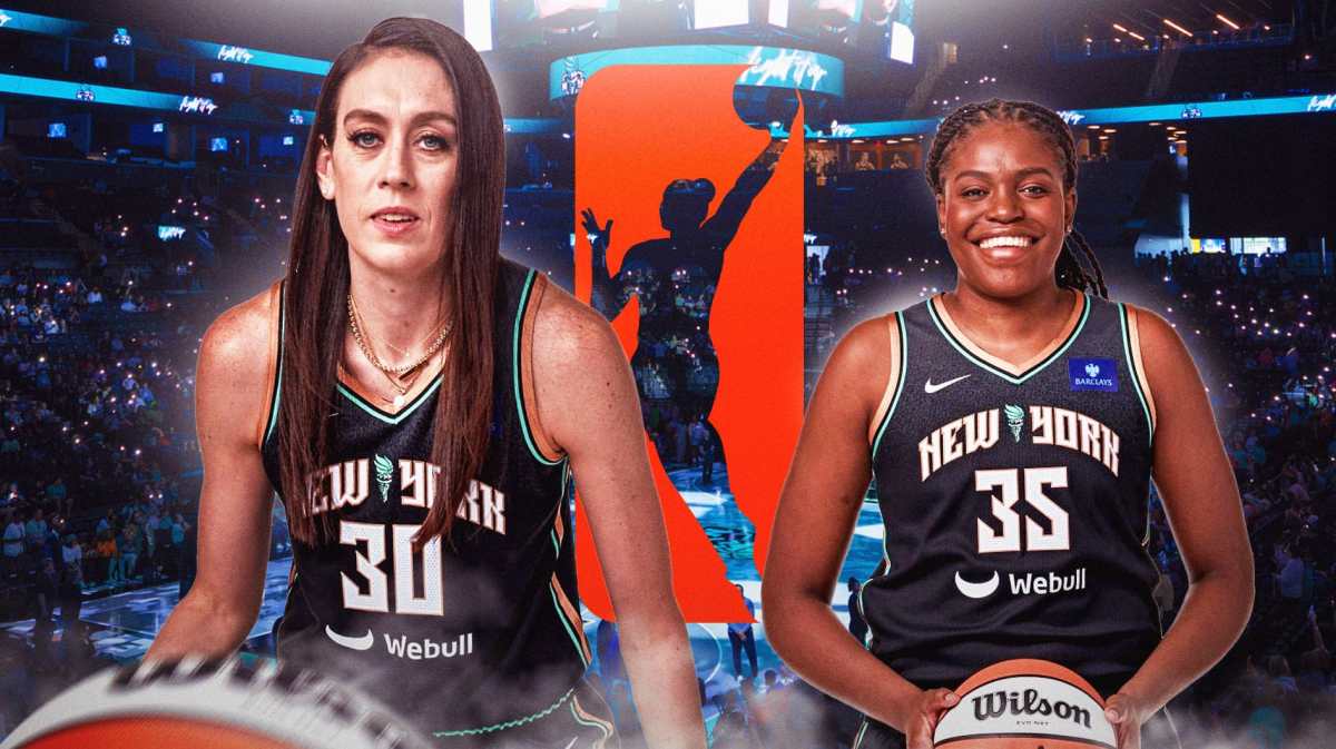 Breanna Stewart and Jonquel Jones (Liberty) in front of Barclays Center crowd with WNBA logo between them