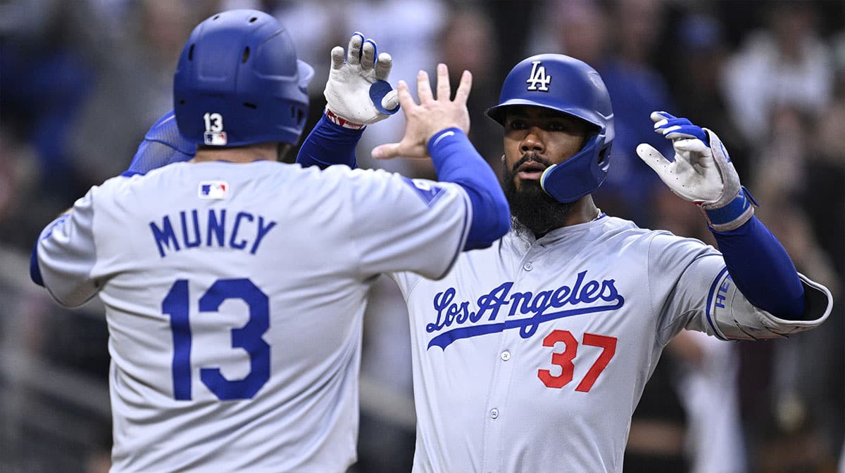 Los Angeles Dodgers left fielder Teoscar Hernandez (37) is congratulated by third baseman Max Muncy (13) after hitting a grand slam home run during the sixth inning against the San Diego Padres at Petco Park. 