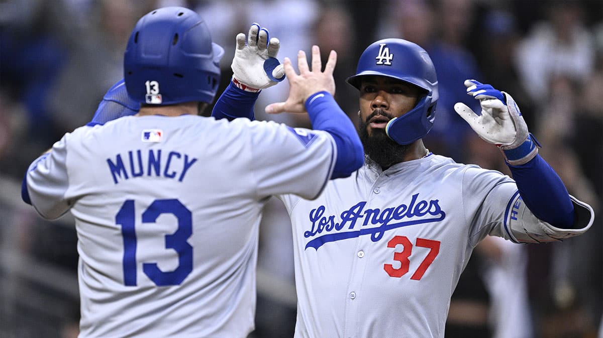 Los Angeles Dodgers left fielder Teoscar Hernandez (37) is congratulated by third baseman Max Muncy (13) after hitting a grand slam home run during the sixth inning against the San Diego Padres at Petco Park.