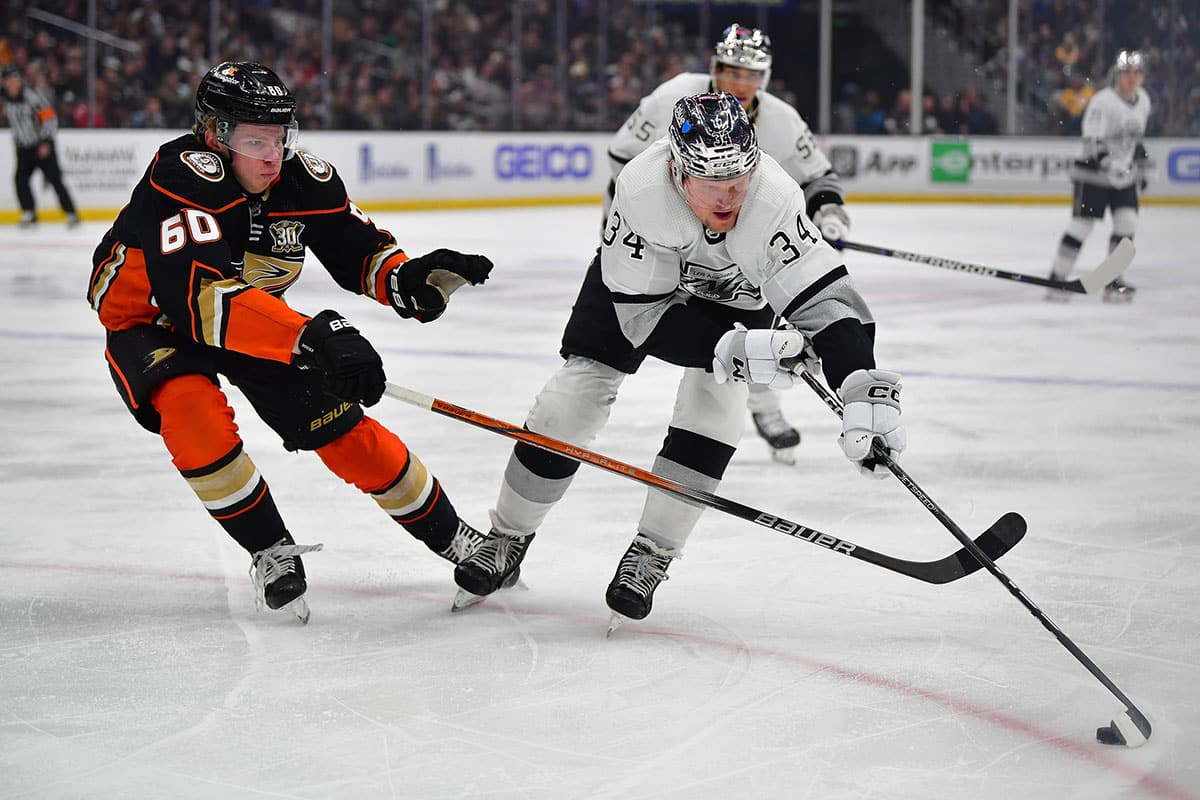 Los Angeles Kings right wing Arthur Kaliyev (34) moves the puck against Anaheim Ducks defenseman Jackson LaCombe (60) during the second period at Crypto.com Arena