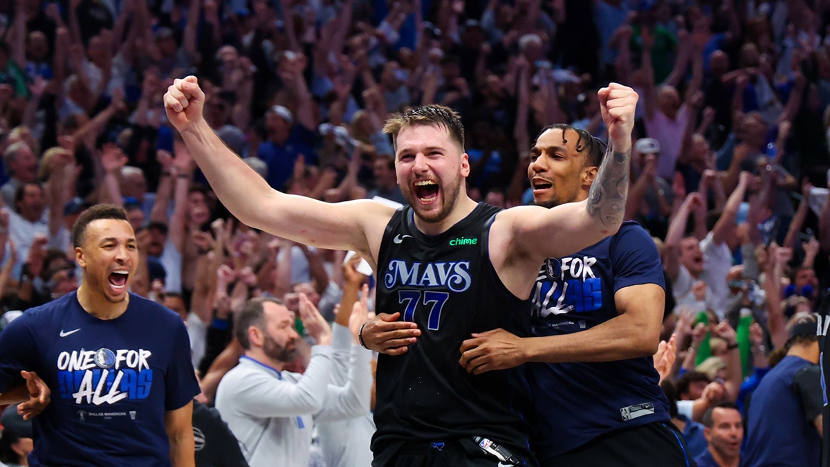 Dallas Mavericks guard Luka Doncic (77) celebrates with teammates after the game against the Oklahoma City Thunder in game six of the second round of the 2024 NBA playoffs at American Airlines Center. 