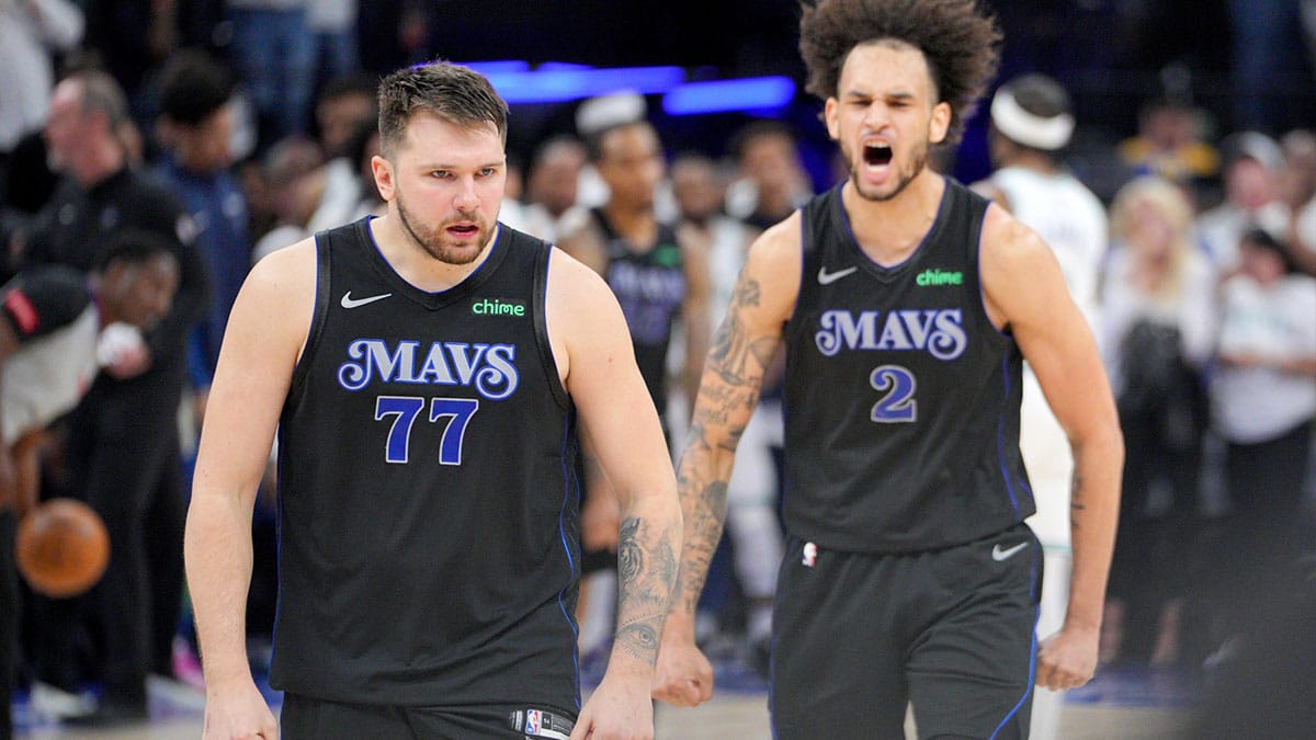 Dallas Mavericks guard Luka Doncic (77) and center Dereck Lively II (2) celebrate in the fourth quarter against the Minnesota Timberwolves in game two of the western conference finals for the 2024 NBA playoffs at Target Center.