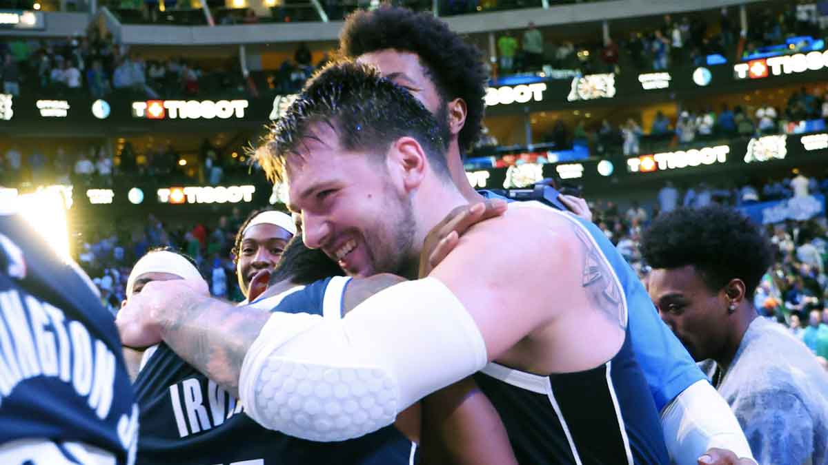 Dallas Mavericks guard Kyrie Irving (11) celebrates with Dallas Mavericks guard Luka Doncic (77) after the win against the Denver Nuggets at American Airlines Center. 