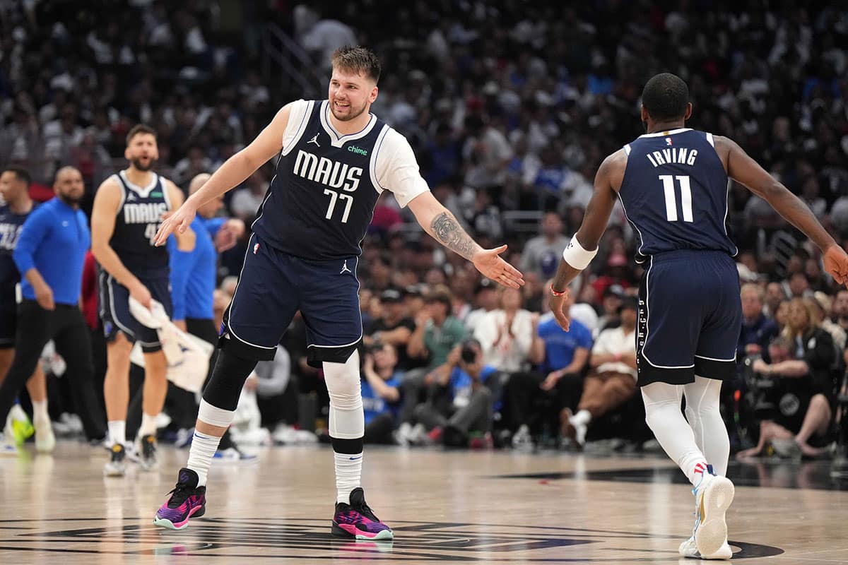 Dallas Mavericks guard Luka Doncic (77) and guard Kyrie Irving (11) celebrate in the second half against the LA Clippers during game five of the first round for the 2024 NBA playoffs at Crypto.com Arena. 