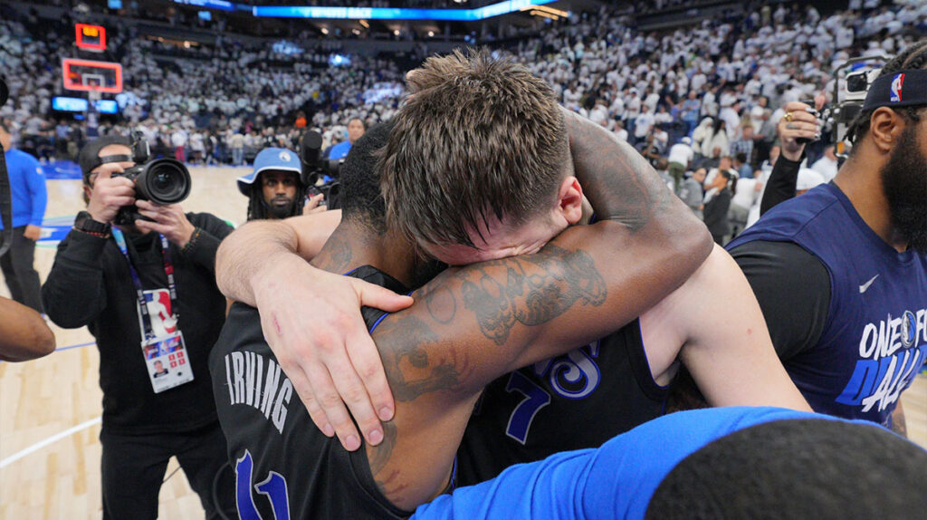 Mavericks duo Luka Doncic and Kyrie Irving hugging after Dallas' Game 2 win over Minnesota