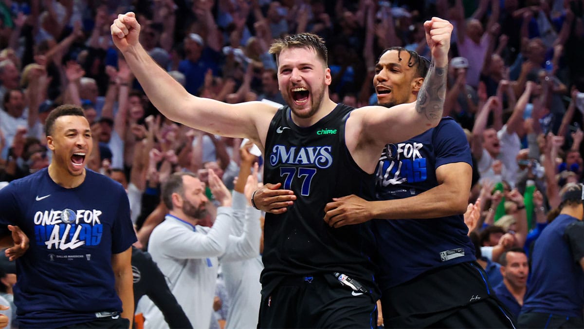 Dallas Mavericks guard Luka Doncic (77) celebrates with teammates after the game against the Oklahoma City Thunder in game six of the second round of the 2024 NBA playoffs at American Airlines Center. 