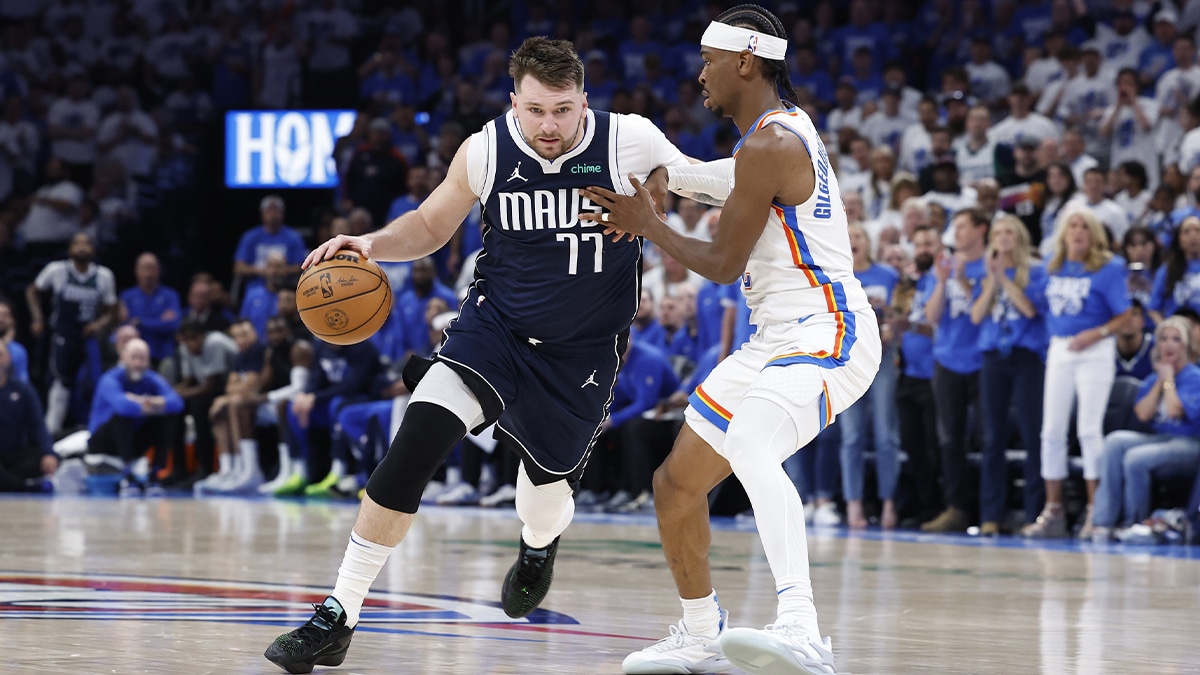 Dallas Mavericks guard Luka Doncic (77) drives to the basket around Oklahoma City Thunder guard Shai Gilgeous-Alexander (2) during the second half of game one of the second round for the 2024 NBA playoffs at Paycom Center.