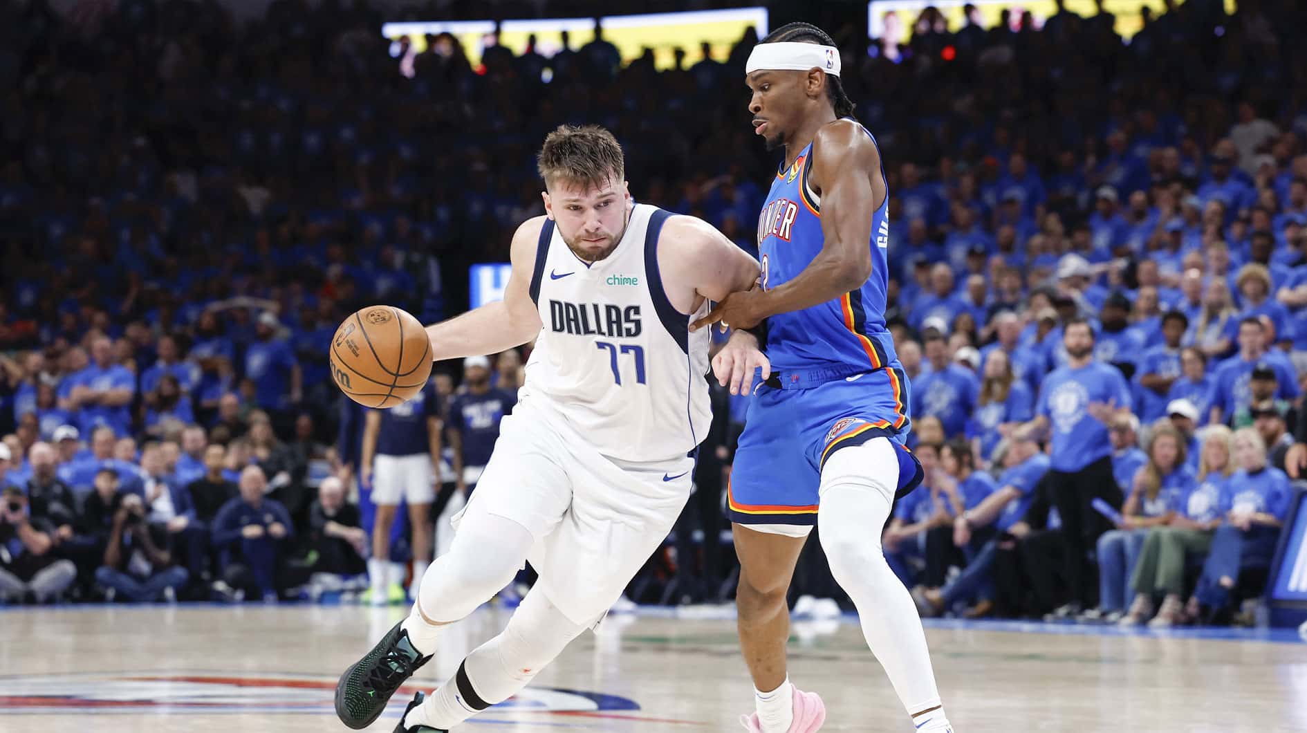 Dallas Mavericks guard Luka Doncic (77) drives to the basket beside Oklahoma City Thunder guard Shai Gilgeous-Alexander (2) during the second half of game two of the second round for the 2024 NBA playoffs at Paycom Center.