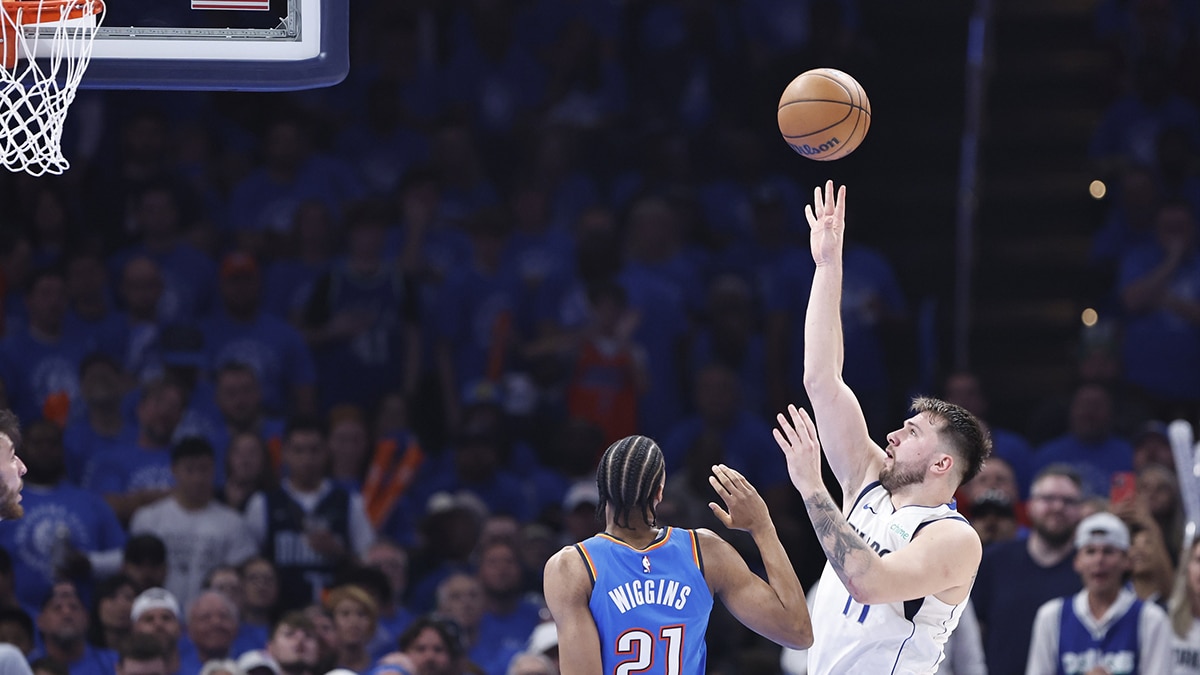 Oklahoma City, Oklahoma, USA; Dallas Mavericks guard Luka Doncic (77) shoots beside Oklahoma City Thunder guard Aaron Wiggins (21) during the second quarter of game two of the second round for the 2024 NBA playoffs at Paycom Center