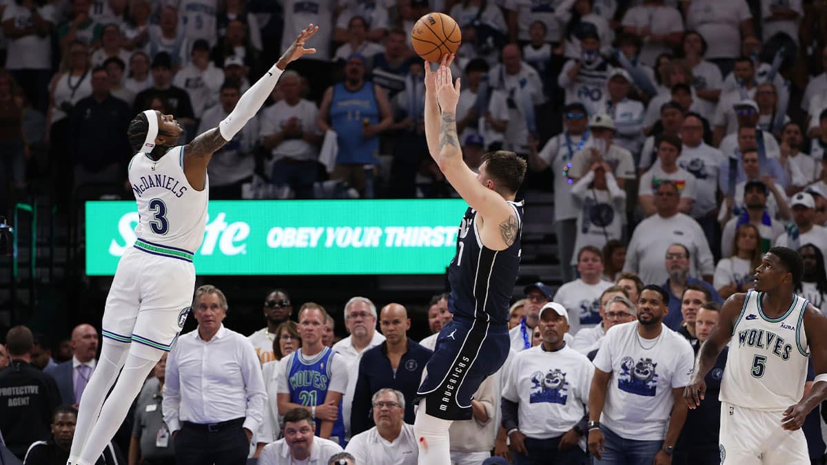 Dallas Mavericks guard Luka Doncic (77) shoots against Minnesota Timberwolves forward Jaden McDaniels (3) in the fourth quarter in game one of the western conference finals for the 2024 NBA playoffs at Target Center.