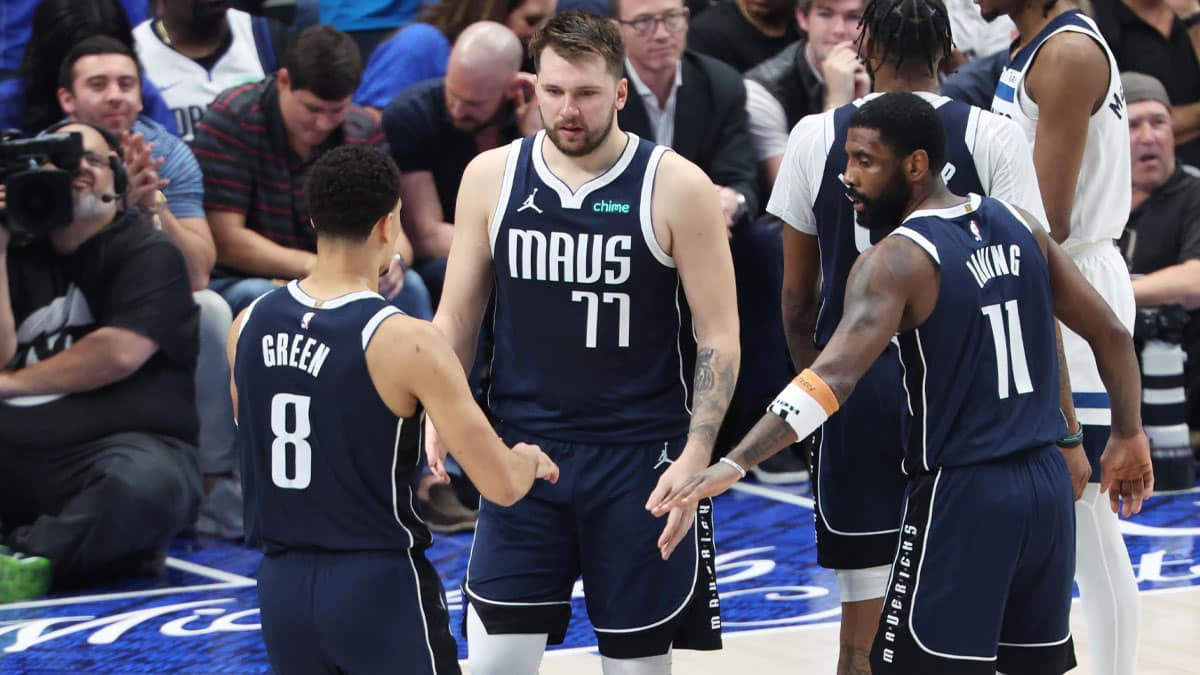 Dallas Mavericks guard Luka Doncic (77) and guard Josh Green (8) and guard Kyrie Irving (11) react in the second half against the Minnesota Timberwolves during game three of the western conference finals for the 2024 NBA playoffs at American Airlines Center